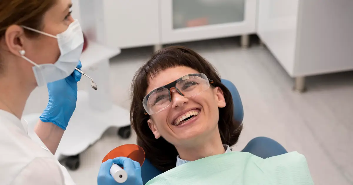 Dentist placing tooth-colored composite filling for patient in Carmichael CA 95608 at Mission Dental